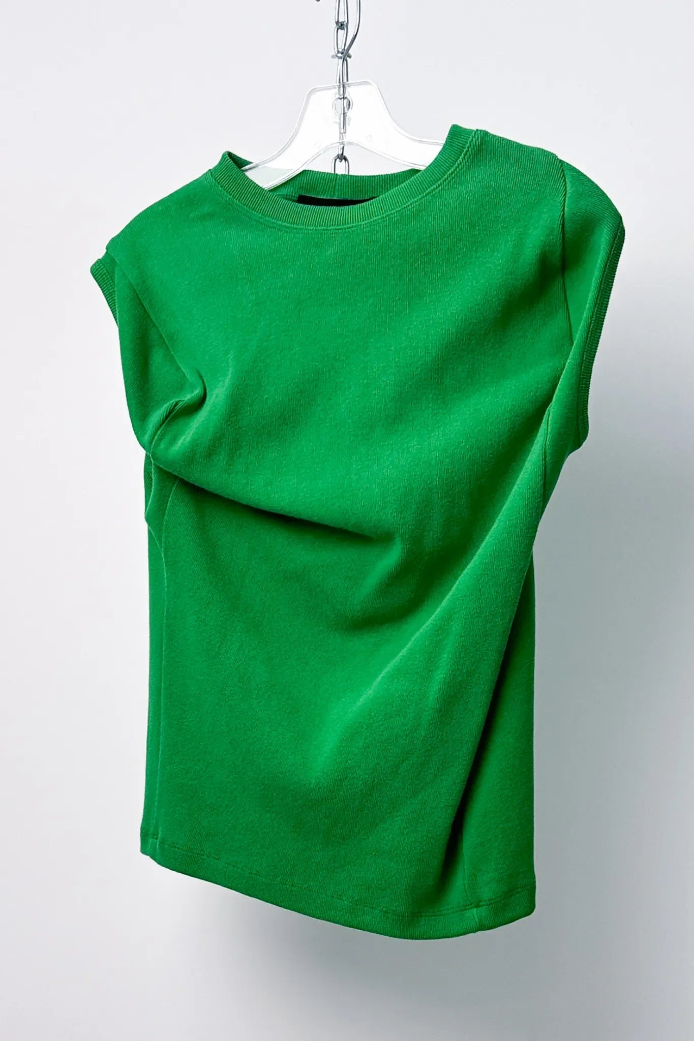 green asymmetric sleeveless wavy top