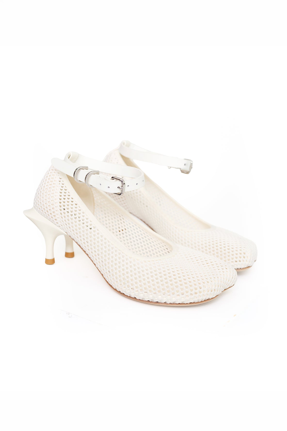 A pair of off-white mesh high-heeled shoes with ankle straps and silver buckles, displayed on a clean white background.