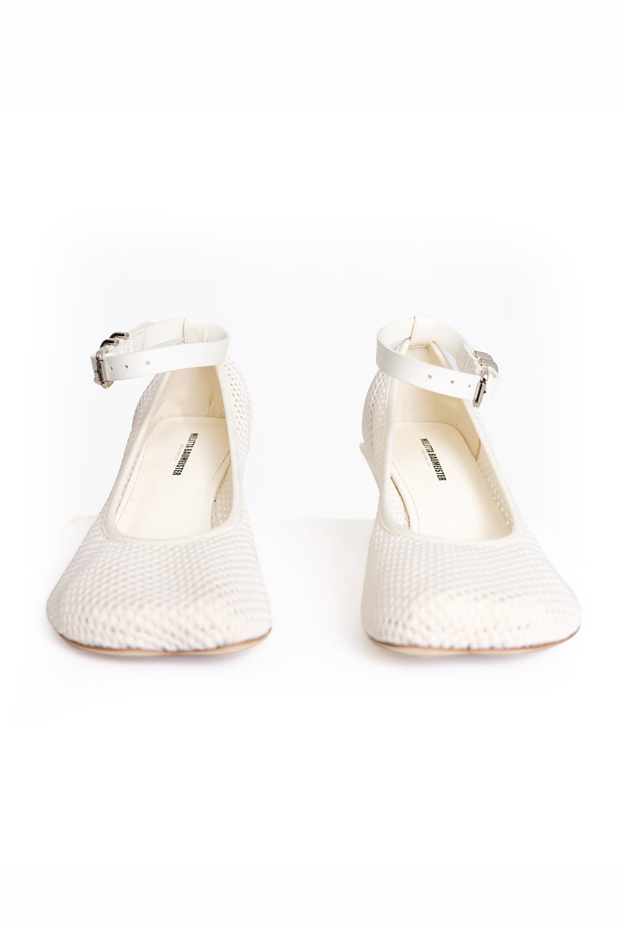 A pair of off-white textured Mary Jane pumps with ankle straps and silver buckles, shown from the front on a white background.