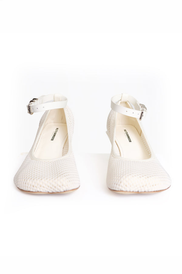 A pair of off-white textured Mary Jane pumps with ankle straps and silver buckles, shown from the front on a white background.