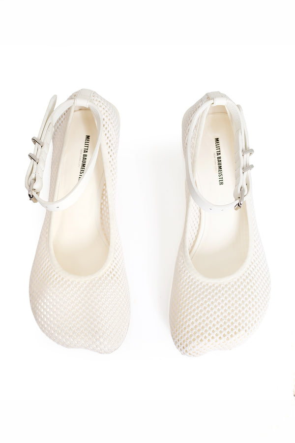 A pair of white Mary Jane-style shoes with a textured mesh upper, ankle strap, and silver buckle, shown from a top-down view on a white background.