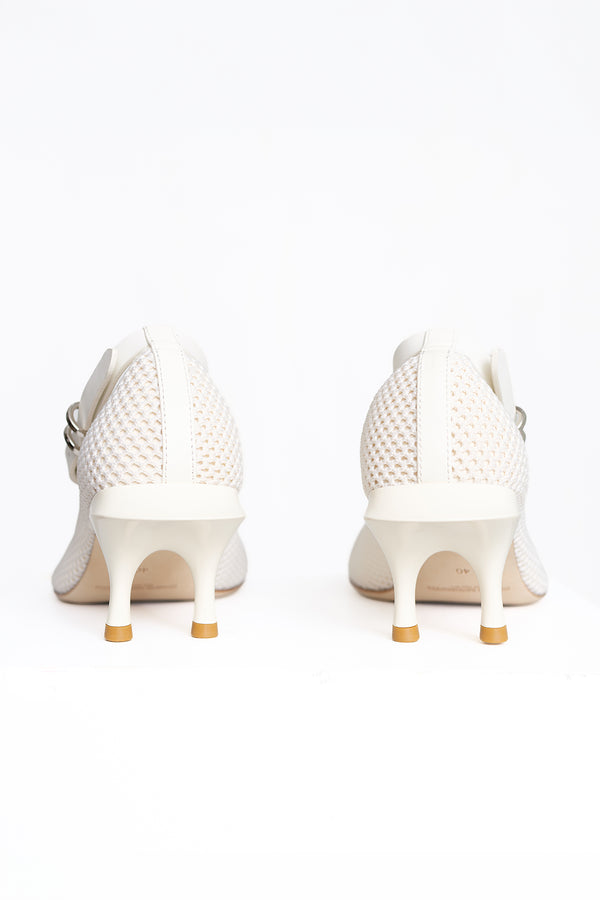 A pair of white high-heeled pumps with textured perforated uppers and kitten heels, shown from the back on a white background.