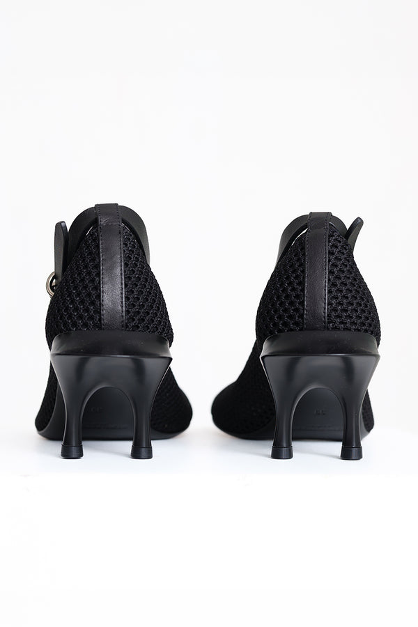 Black high-heeled ankle boots with a textured mesh upper and a side buckle strap, shown from the back against a white background.