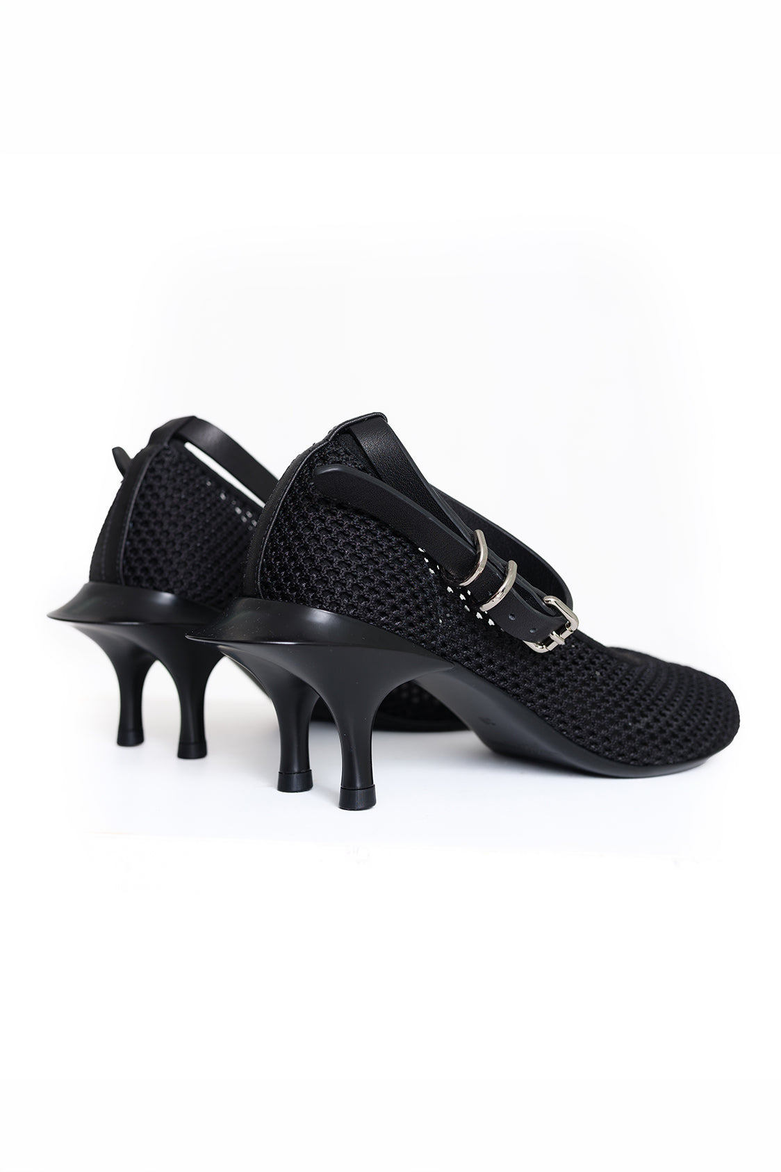 Pair of black kitten-double-heeled shoes on a white background