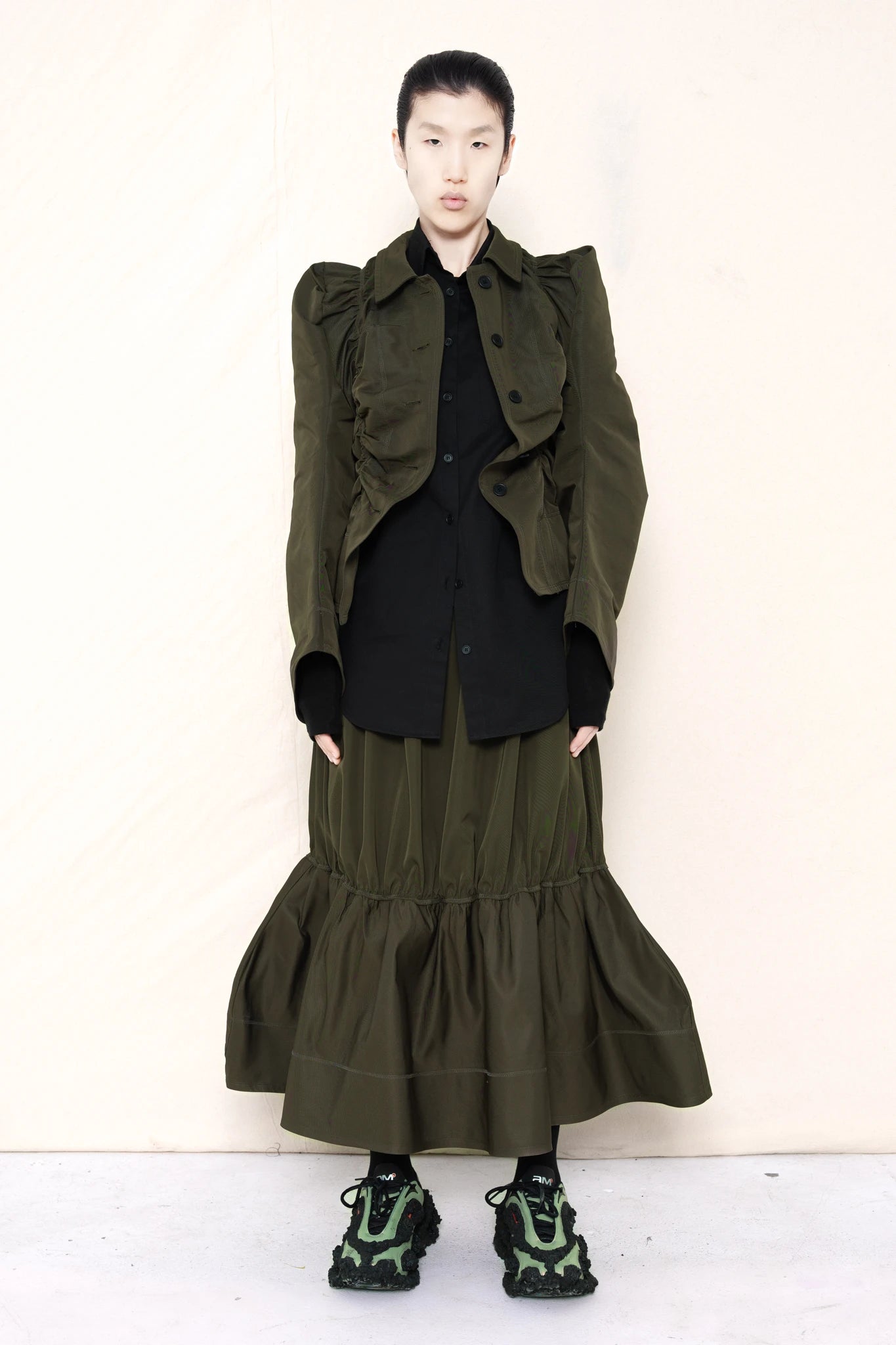 PERSON-WEARING-MOSS-RUCHED-JACKET-OVER-BLACK-BUTTON-DOWN-WITH-MOSS-RUCHED-SKIRT-AND-CUSTOMIZED-SNEAKERS-FRONT-VIEW