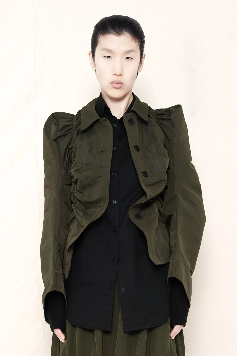 PERSON-WEARING-MOSS-RUCHED-JACKET-OVER-BLACK-BUTTON-DOWN-WITH-MOSS-RUCHED-SKIRT-AND-CUSTOMIZED-SNEAKERS-FRONT-VIEW