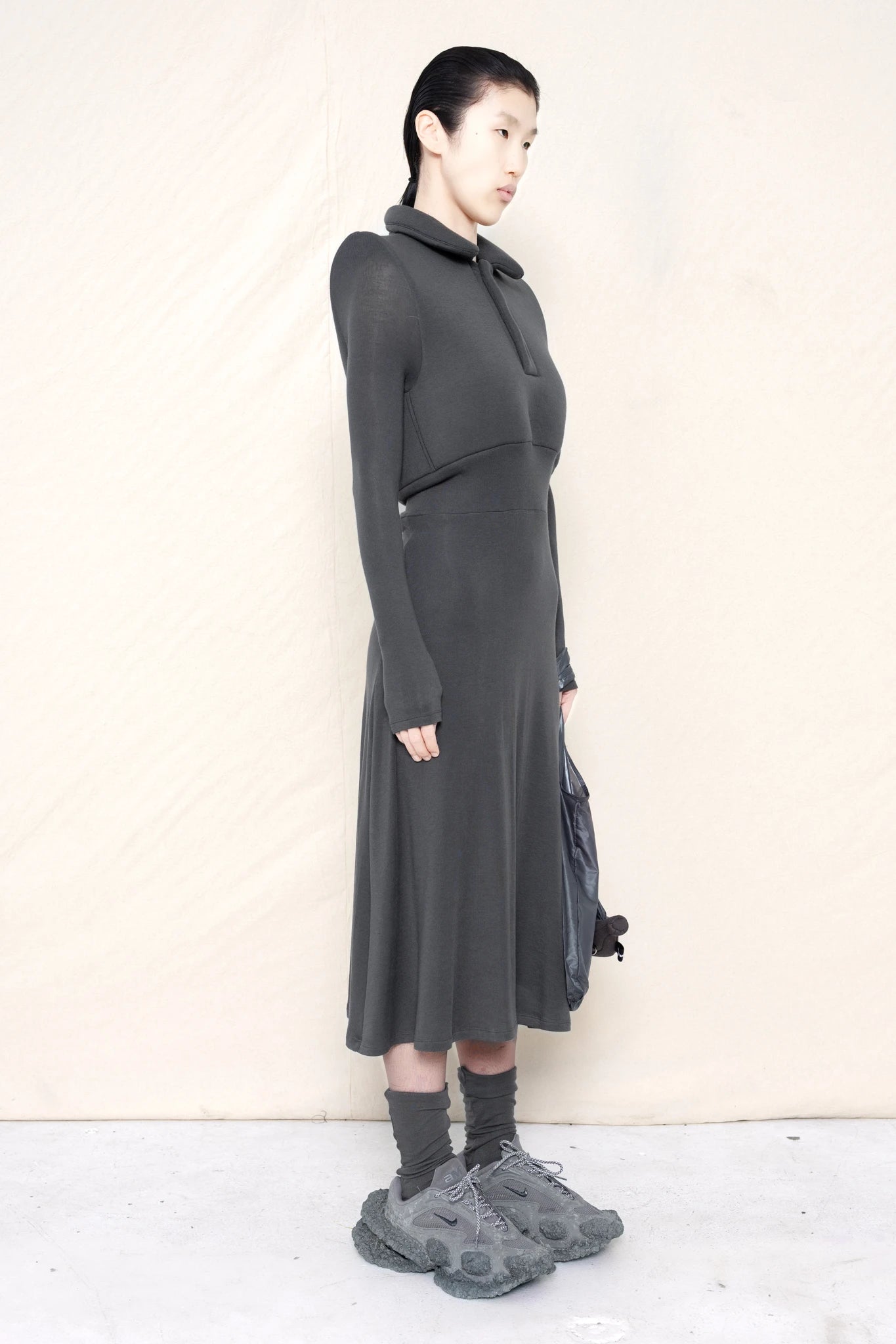 PERSON-WEARING-WARM-GREY-FOAMY-POLO-LONGSLEEVE-DRESS-WITH-MATCHING-SOCKS-AND-CUSTOMIZED-SNEAKERS-HOLDING-WARM-GREY-BANANA-TOTE-BAG-THREE-QUARTER-VIEW