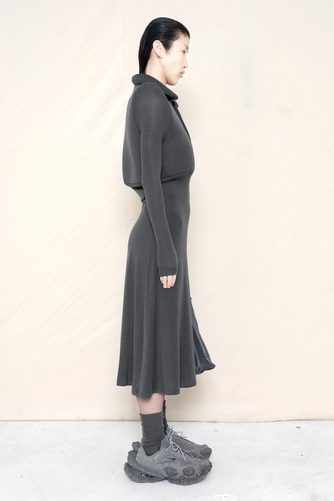 PERSON-WEARING-WARM-GREY-FOAMY-POLO-LONGSLEEVE-DRESS-WITH-MATCHING-SOCKS-AND-CUSTOMIZED-SNEAKERS-SIDE-VIEW