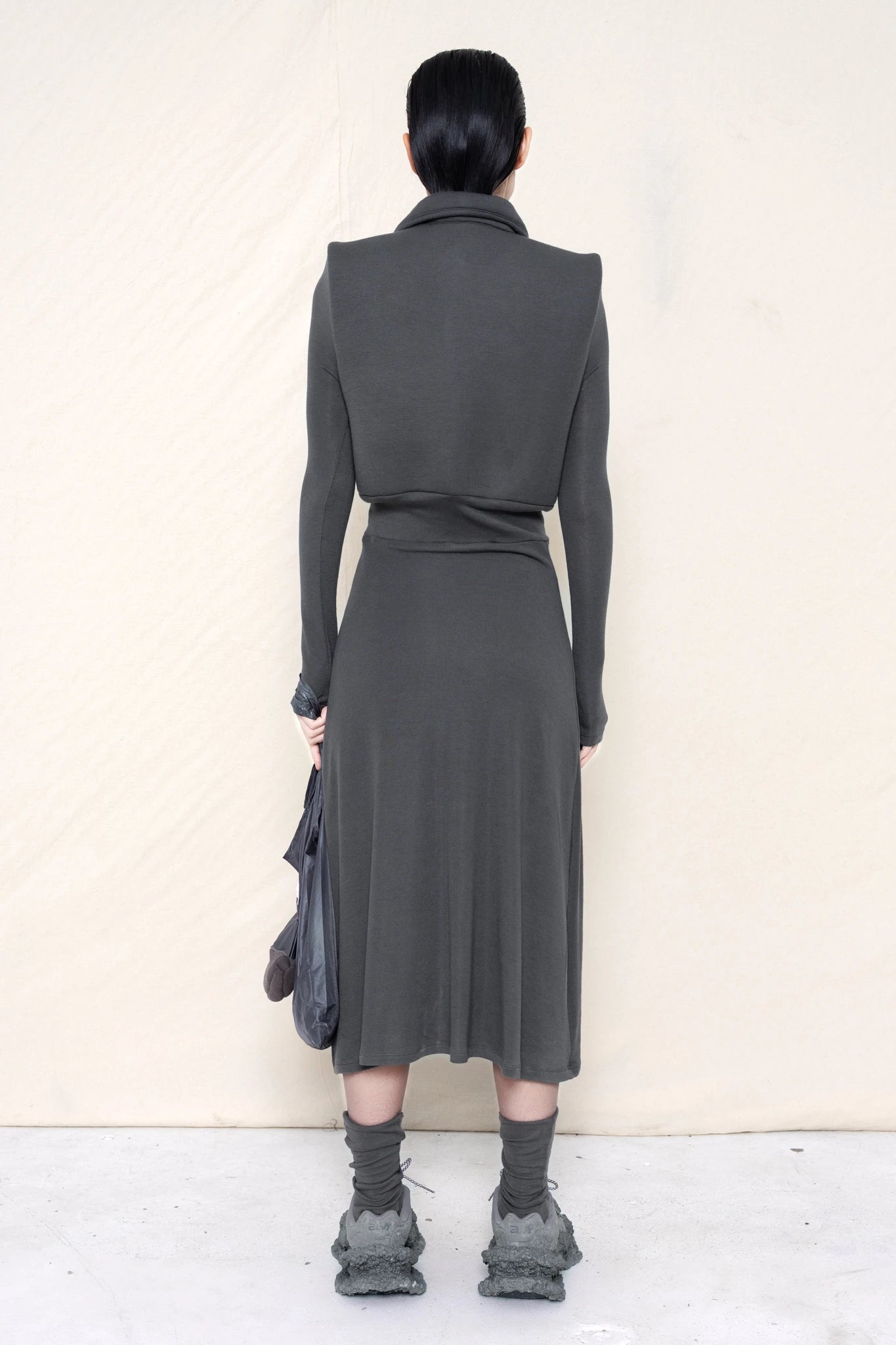 PERSON-WEARING-WARM-GREY-FOAMY-POLO-LONGSLEEVE-DRESS-WITH-MATCHING-SOCKS-AND-CUSTOMIZED-SNEAKERS-HOLDING-WARM-GREY-BANANA-TOTE-BAG-BACK-VIEW