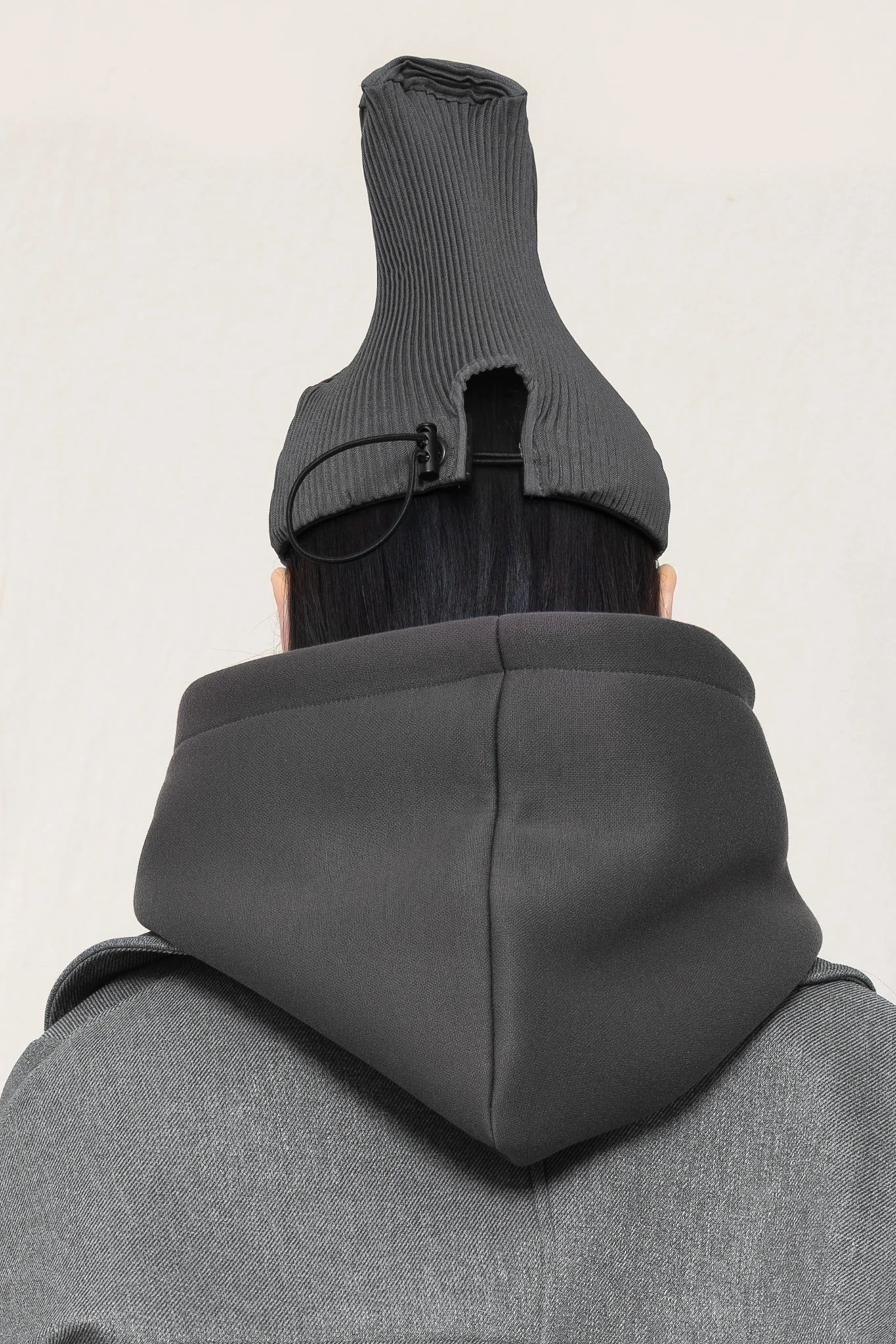 PERSON-WEARING-POINTY-PLEATED-COLD-GREY-CAP-WITH-ADJUSTABLE-STRAP-CLOSE-UP-BACK-VIEW
