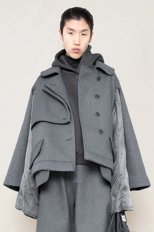 A-model-wearing-A-grey-DOUBLE-LAPEL-JACKET-WITH-grey-SILKY-SECOND-SLEEVEs-over-a-spongey-grey-hoodie-and-grey-trousers-front-view