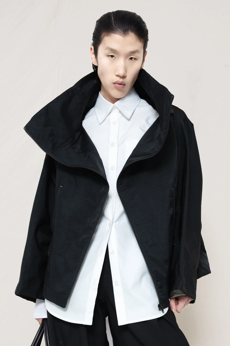 PERSON-WEARING-BLACK-BOXY-ZIP-UP-JACKET-WITH-WHITE-BUTTON-DOWN-AND-BLACK-TAILORED-PANTS-FRONT-VIEW