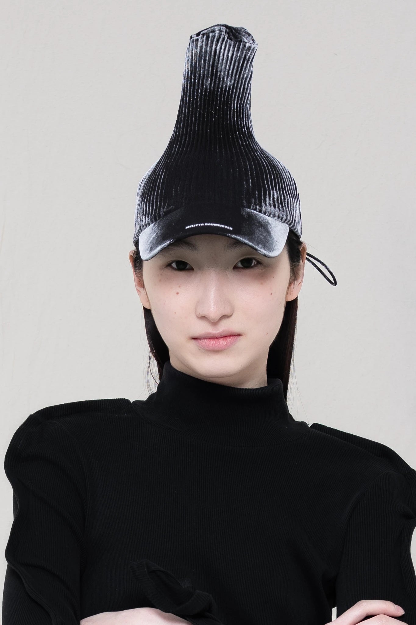 PERSON-WEARING-POINTY-PLEATED-PAINTED-GLOW-CAP-CLOSE-UP-FRONT-VIEW