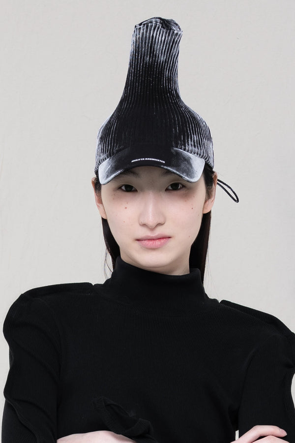 PERSON-WEARING-POINTY-PLEATED-PAINTED-GLOW-CAP-CLOSE-UP-FRONT-VIEW