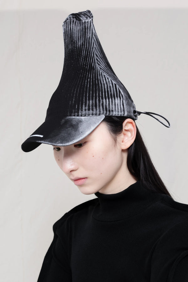 PERSON-WEARING-POINTY-PLEATED-PAINTED-GLOW-CAP-CLOSE-UP-THREE-QUARTER-VIEW