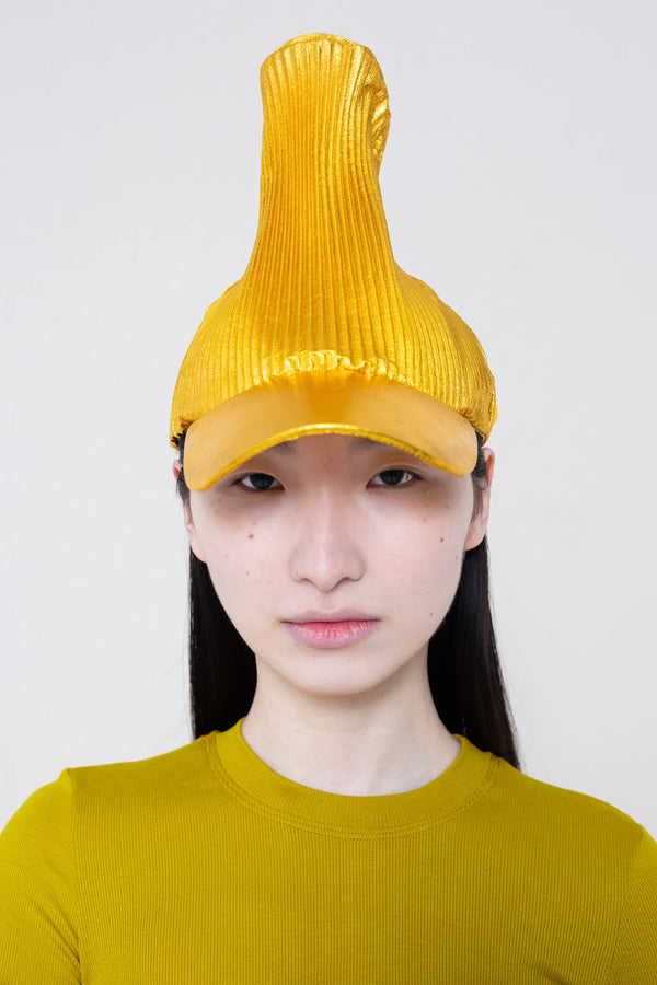 PERSON-WEARING-POINTY-PLEATED-GOLD-CAP-CLOSE-UP-FRONT-VIEW