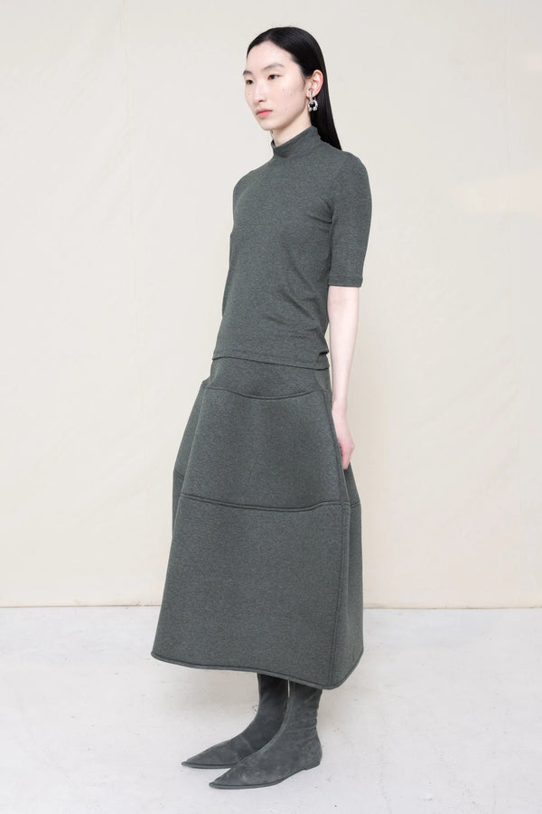 PERSON-WEARING-MELANGE-MOCK-NECK-WITH-MATCHING-FOAMY-BALL-SKIRT-AND-GREY-FLAT-POINTY-BOOTS-THREE-QUARTER-VIEW