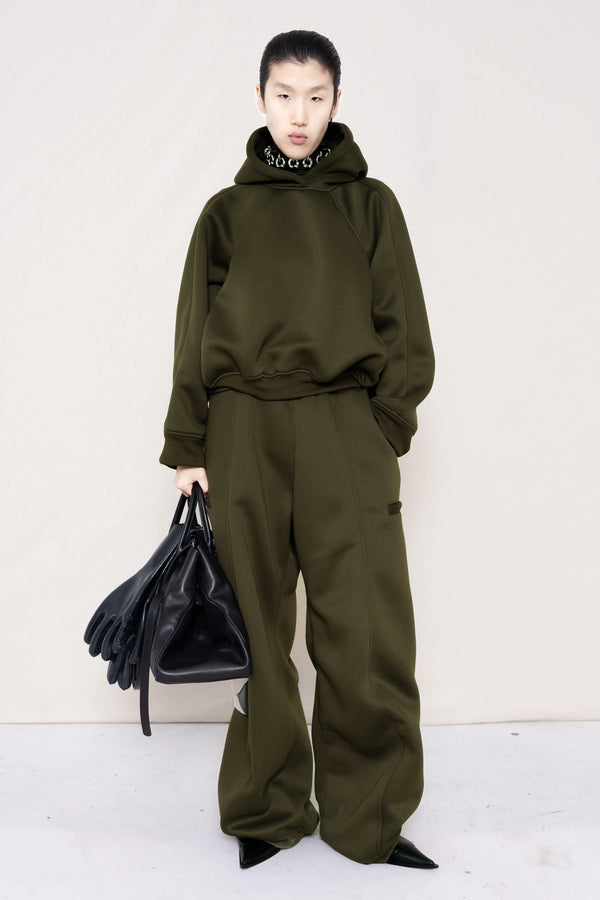 PERSON-WEARING-MOSS-CROPPED-HOODIE-WITH-MATCHING-MOSS-ROUND-LEG-LOUNGEPANTS-AND-PIERCED-CHOKER-WITH-BLACK-FLAT-POINTY-BOOTS-HOLDING-BLACK-COWHIDE-A-LINE-SHOPPER-BAG-FRONT-VIEW