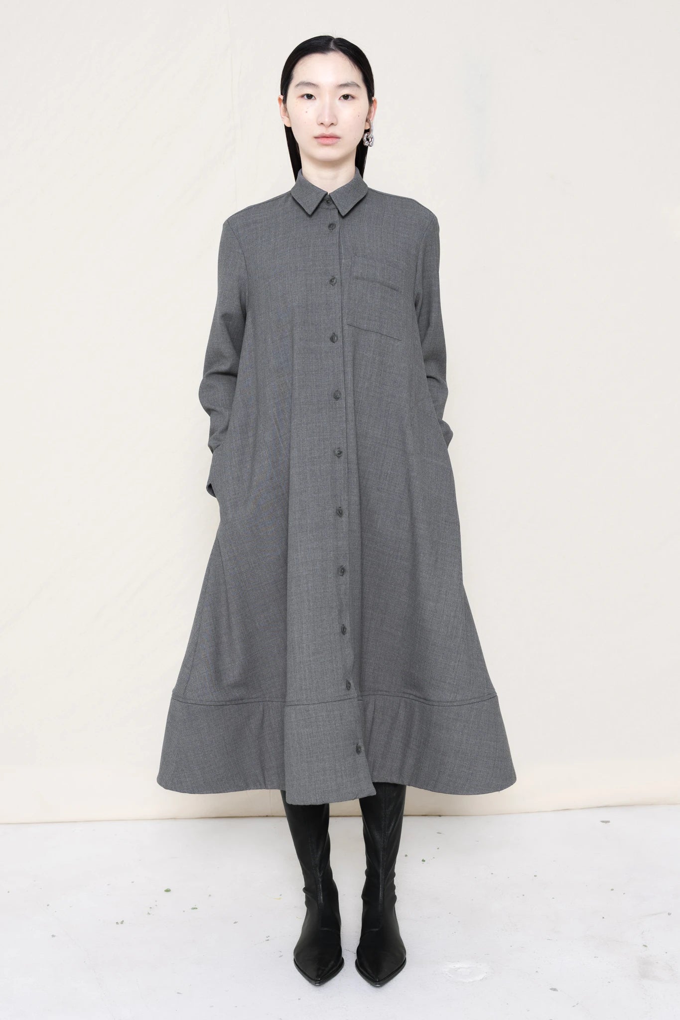 PERSON-WEARING-GREY-COLLARED-FOAM-BOTTOM-BUTTON-DOWN-SHIRT-DRESS-WITH-BLACK-FLAT-POINTY-BOOTS-FRONT-VIEW