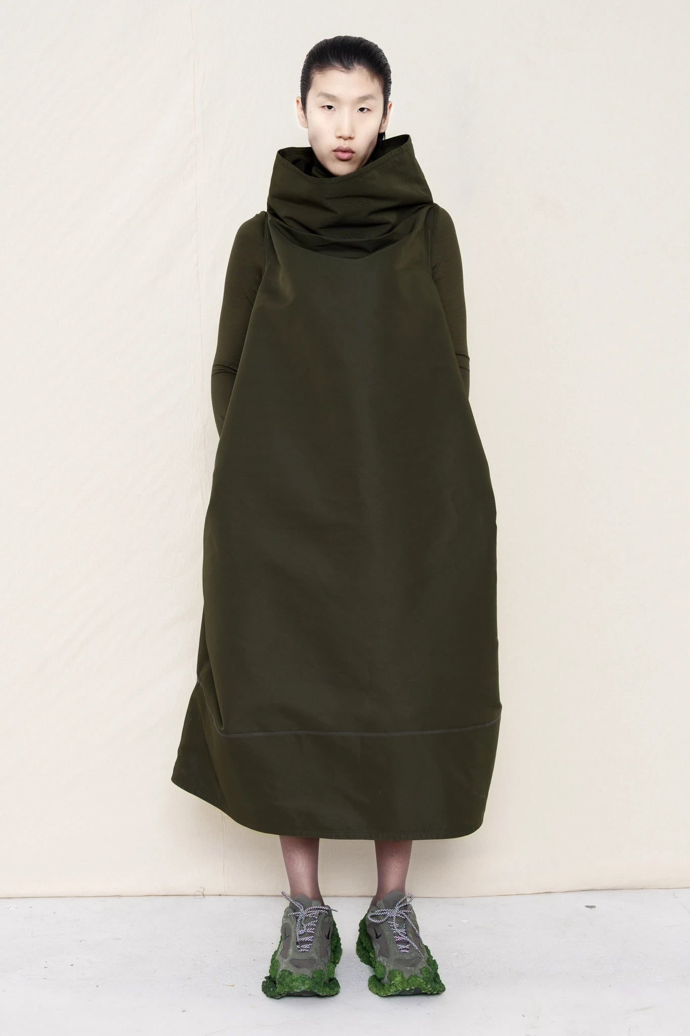 PERSON-WEARING-MOSS-HIGH-COLLAR-DRESS-OVER-MATCHING-COLORED-LONGSLEEVE-WITH-CUSTOMIZED-SNEAKERS-FRONT-VIEW