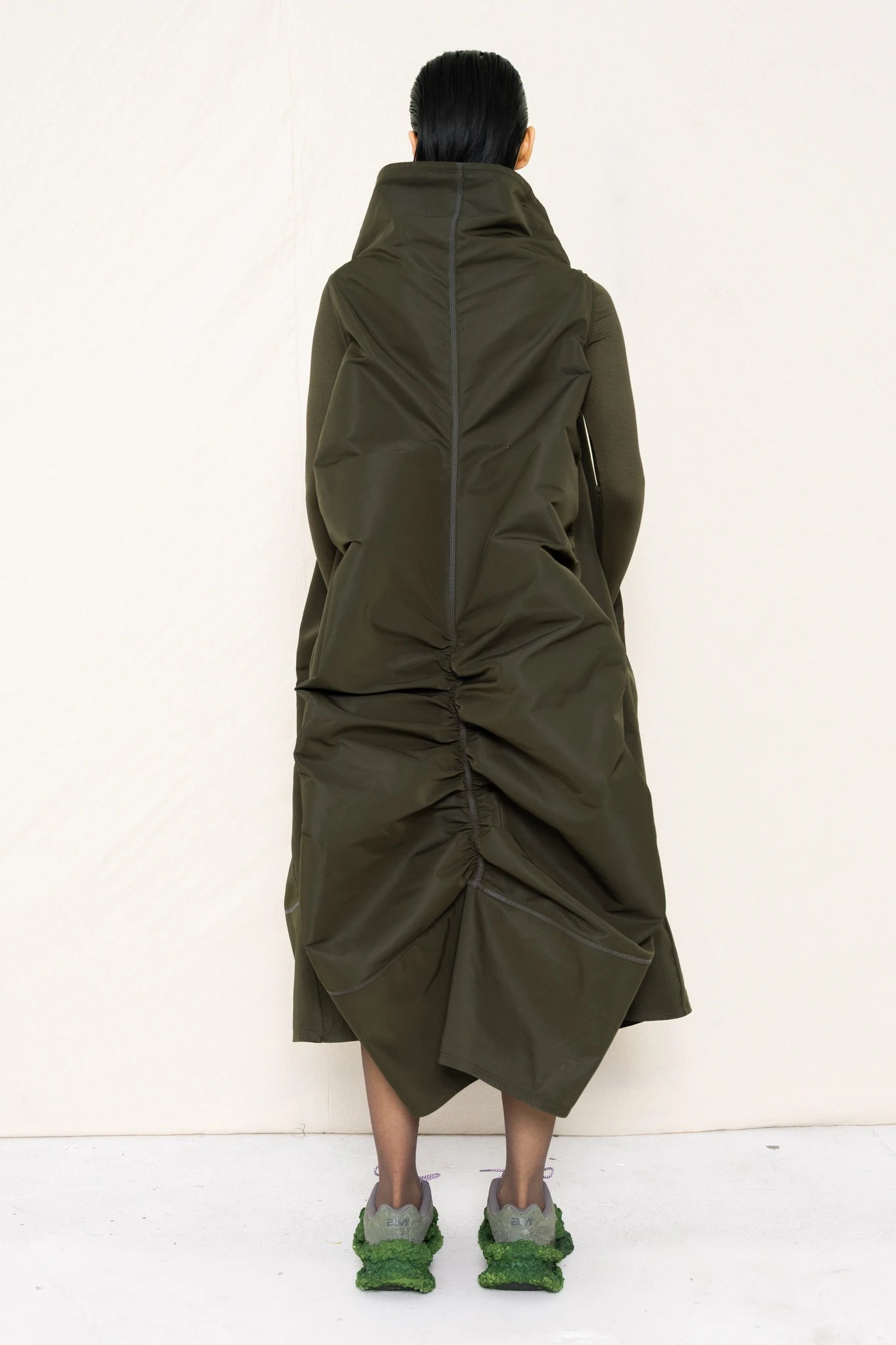 PERSON-WEARING-MOSS-HIGH-COLLAR-DRESS-WITH-RUCHED-BACK-DETAILING-OVER-MATCHING-COLORED-LONGSLEEVE-WITH-CUSTOMIZED-SNEAKERS-BACK-VIEW