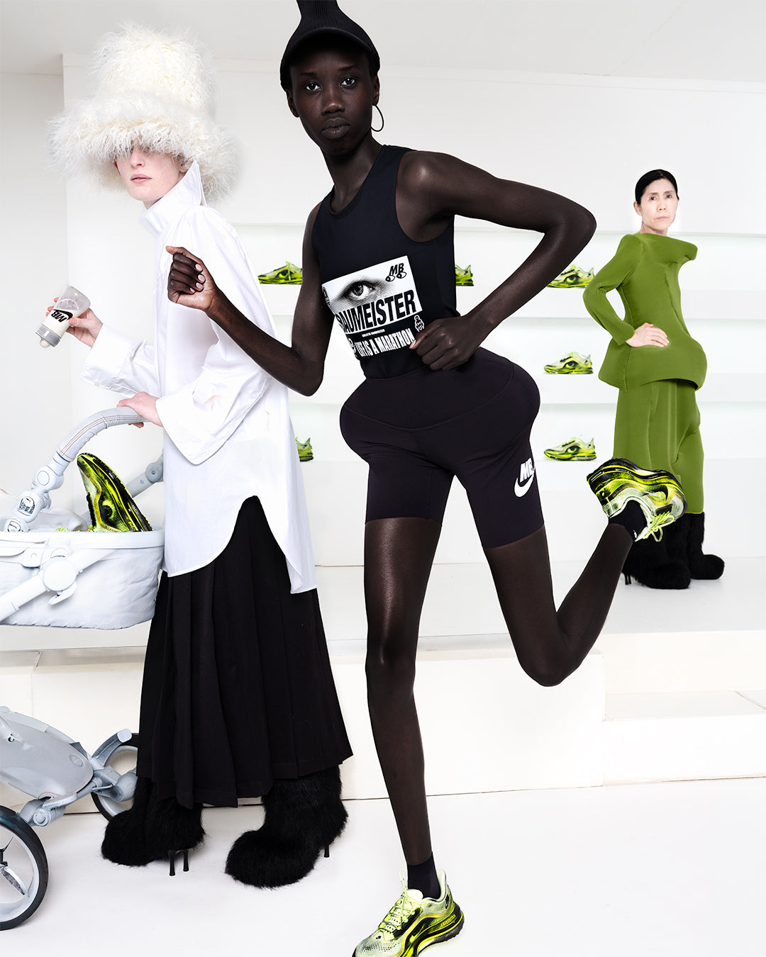 Three models in a multi-layered shot in a white room wearing green shoes