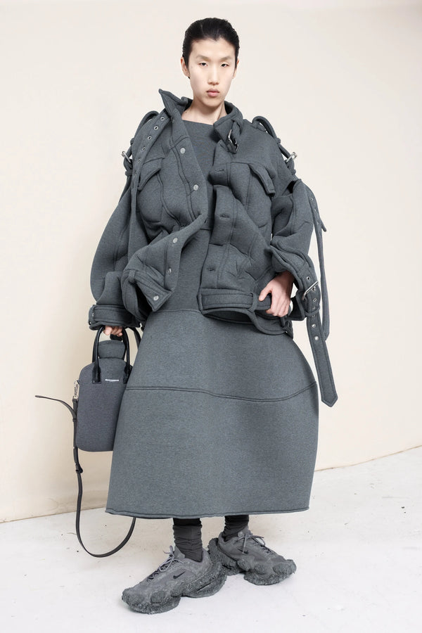 PERSON-WEARING-MELANGE-BELTED-ZIGZAG-JACKET-WITH-MATCHING-MELANGE-FOAMY-BALL-SKIRT-ACCESSORIZED-WITH-MELANGE-HOT-WATER-BOTTLE-BAG-AND-CUSTOMIZED-SNEAKERS-FRONT-VIEW