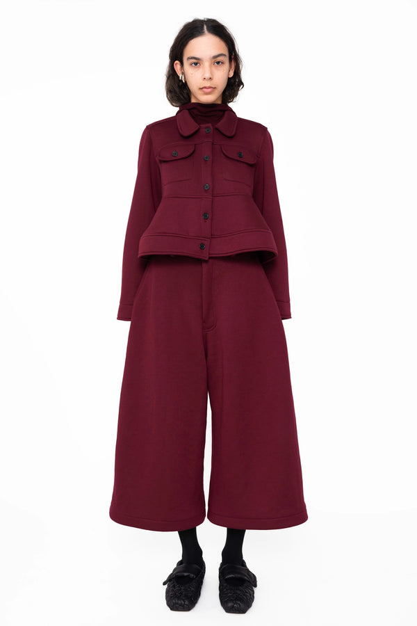 female-wearing-cropped-bordeaux-jacket-with-pockets-and-sculptural-hem-with-cropped-bordeaux-lounge-pants-on-white-background-full-body-front