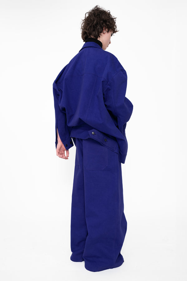 male-wearing-deep-blue-double-waist-denim-pants-with-wide-leg-and-deep-blue-denim-jacket-on-white-background-full-body-three-quarter