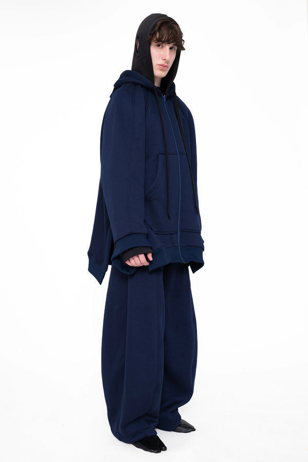 male-wearing-navy-round-leg-lounge-pants-with-navy-double-hood-zip-up-hoodie-on-white-background-full-body-three-quarter
