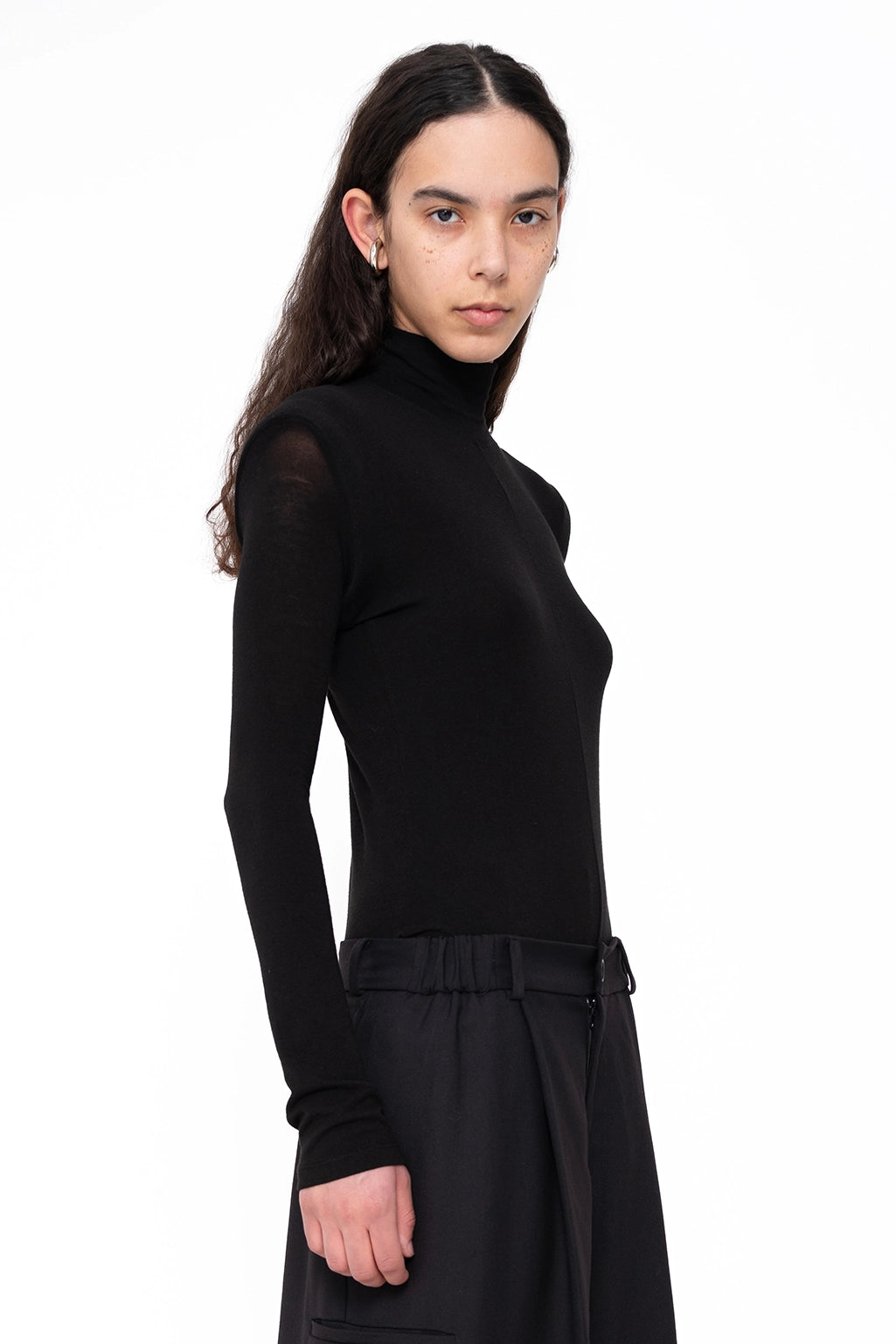 female-wearing-back-longsleeve-turtleneck-with-shoulder-detail-on-white-background-close-up-three-quarter