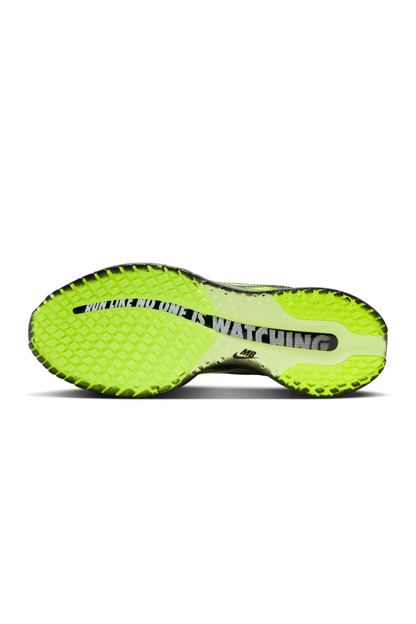 Neon green and black colored athletic shoe sole on a white background