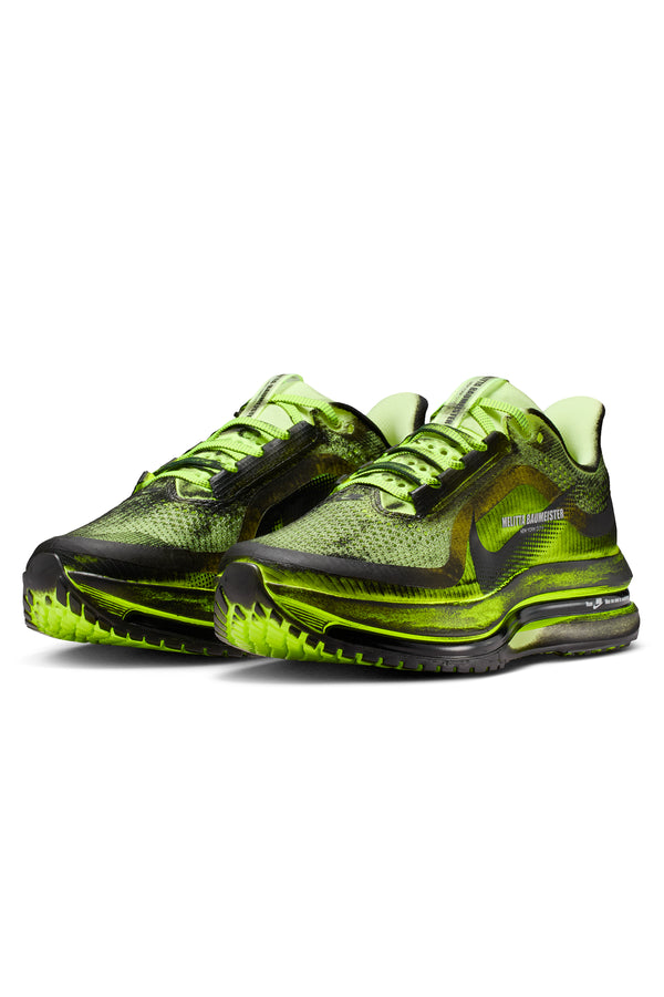 Pair of neon green and black running shoes on a white background