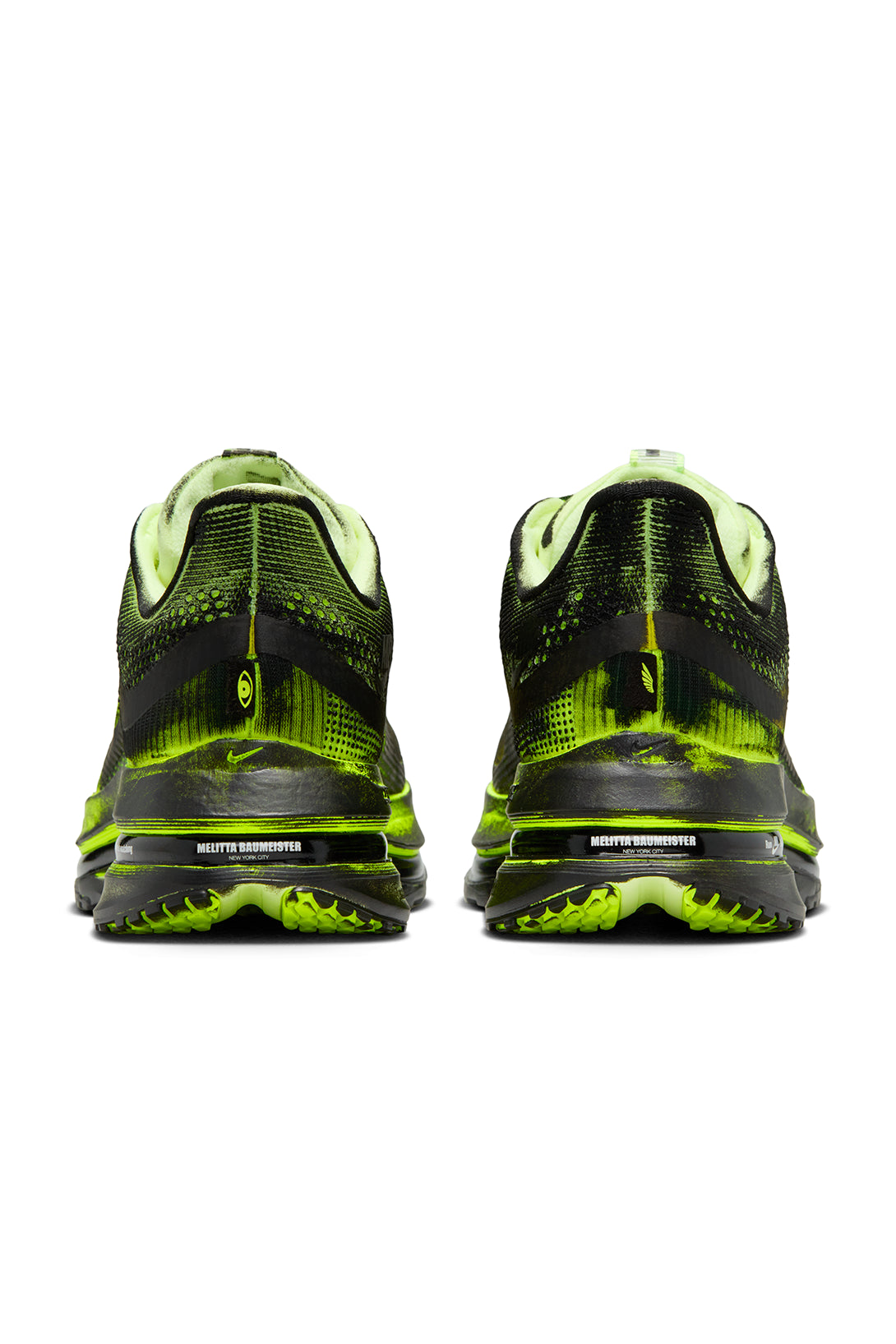 Back of black and green running shoes on a white background