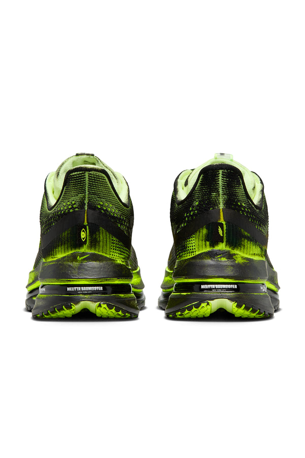 Back of black and green running shoes on a white background