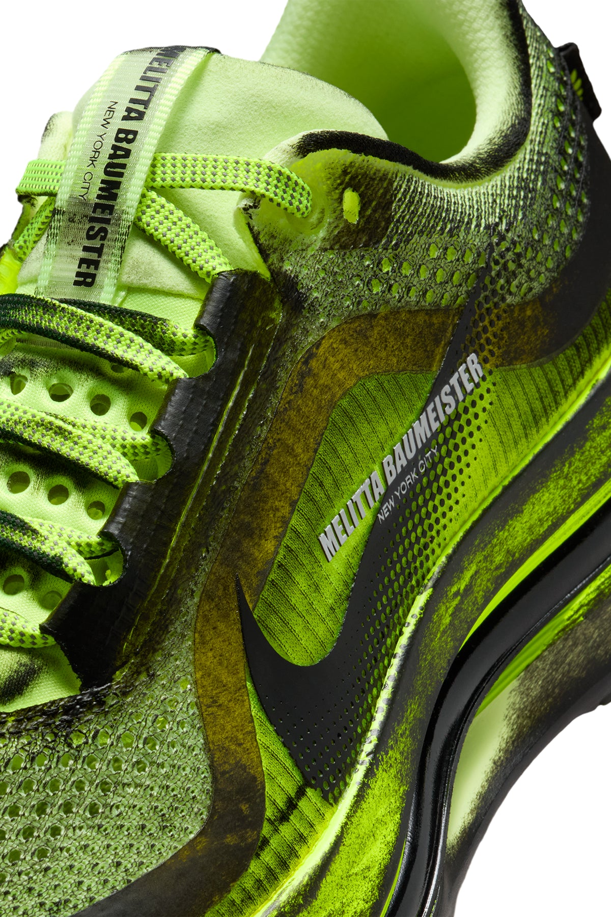 Close-up of a neon green and black sneaker with 'MELITTA BAUMEISTER' and 'NIKE' branding.