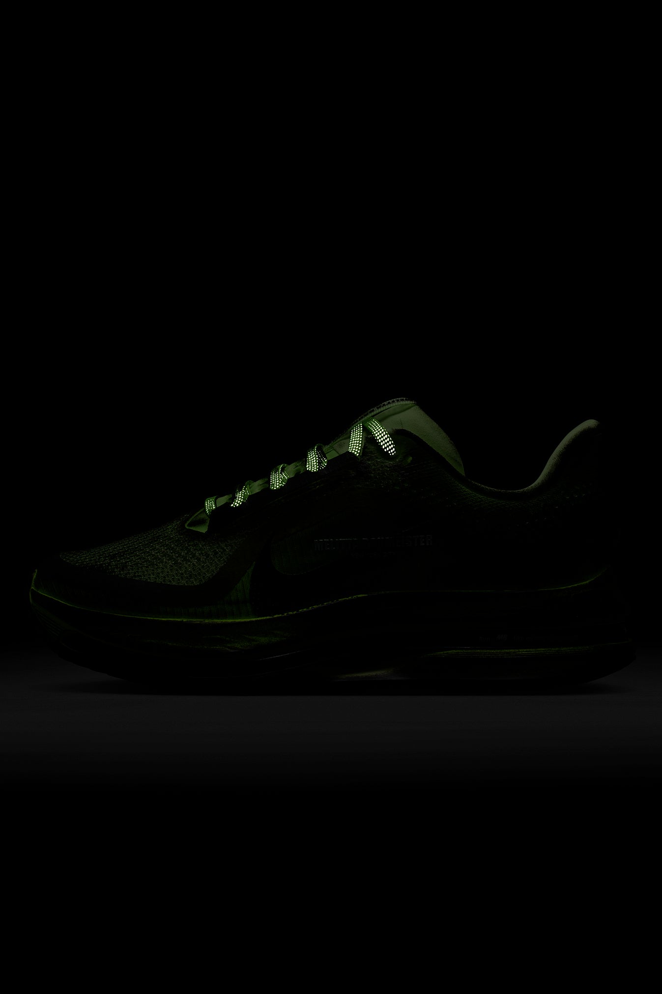 Black sneaker with glowing sole on a black background
