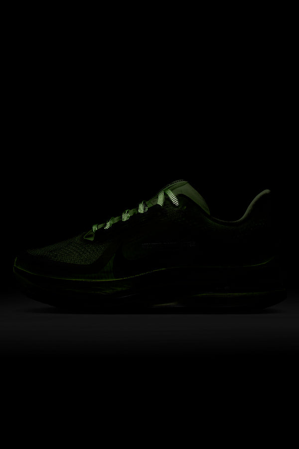 Black sneaker with glowing sole on a black background
