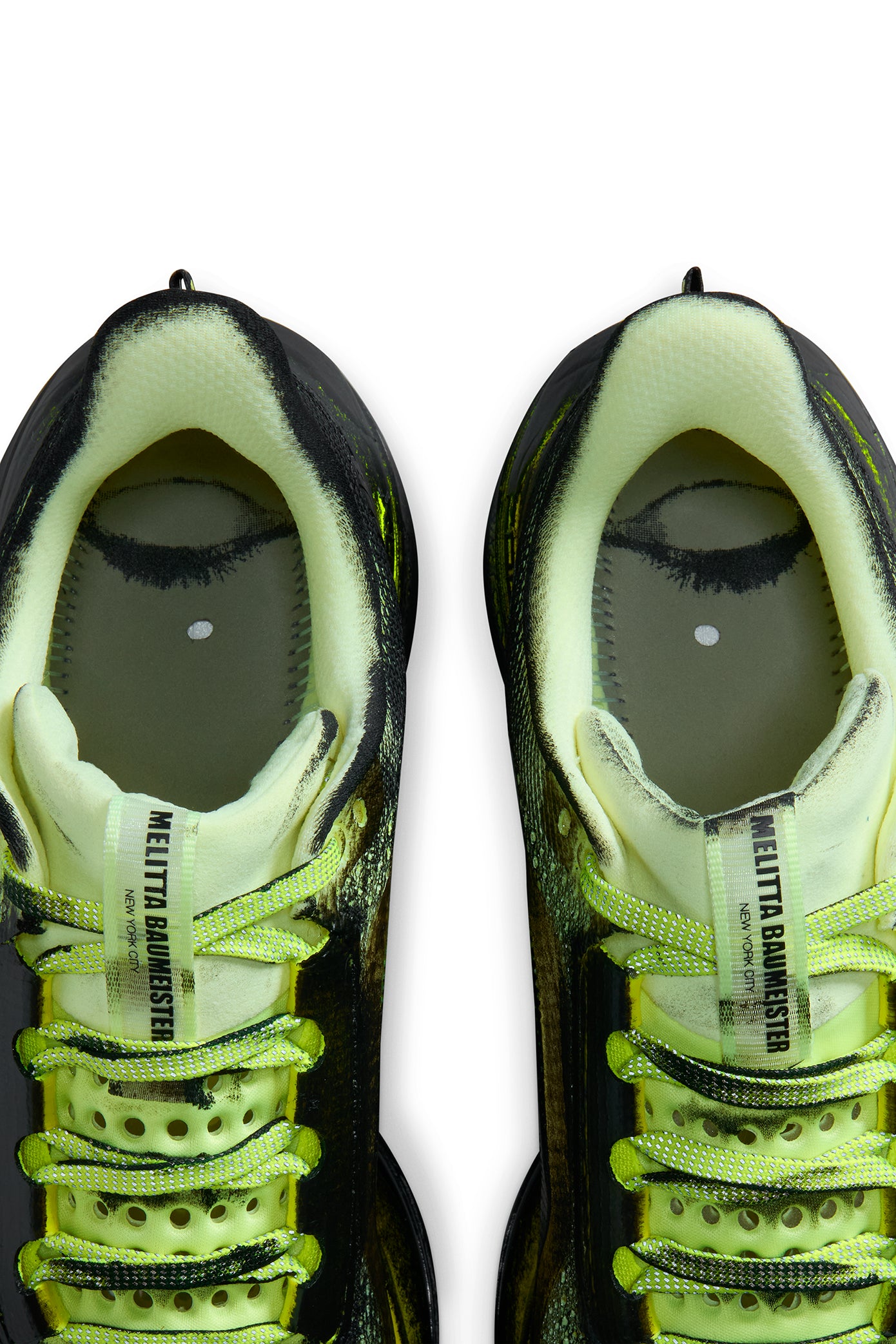 Pair of neon green and black sneakers on a white background. Photo of insoles taken out