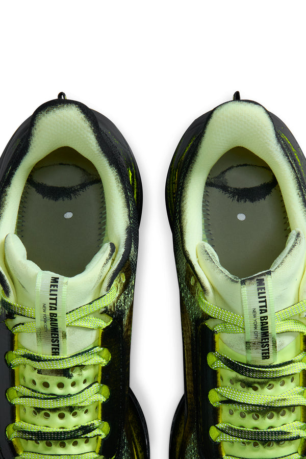 Pair of neon green and black sneakers on a white background. Photo of insoles taken out