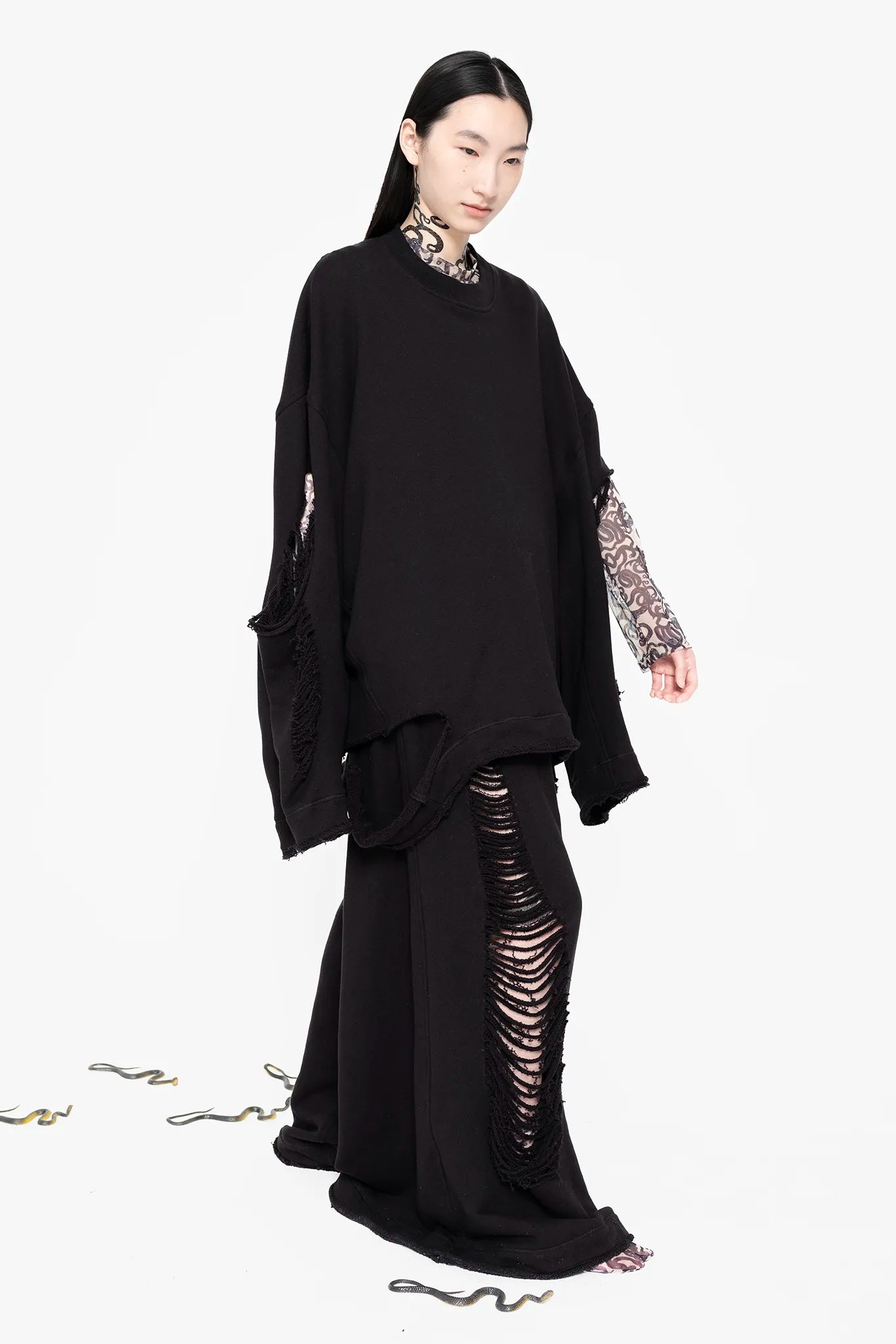 MELITTA-BAUMEISTER-Crewneck-Sweater-Black-Slight-Right-Side-View-Model-In-Motion-Walking-Forward