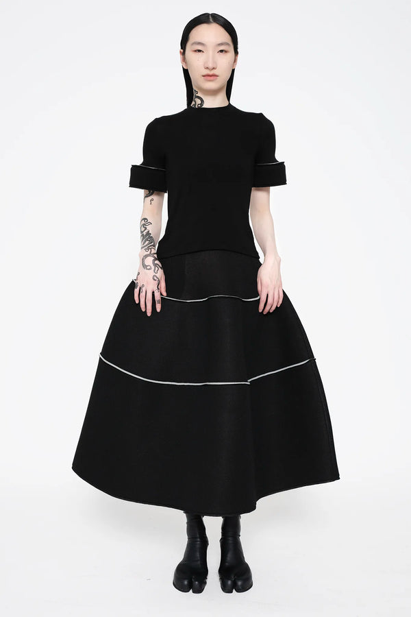 MELITTA-BAUMEISTER-Foam-Cuff-Tee-in-Black-BLACK-LONG-HAIR-FEMALE-MODEL-ALSO-WEARING-BLACK-LEATHER-SHOES