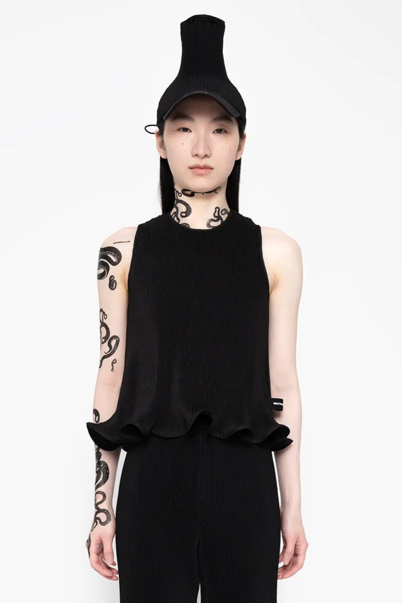 MELITTA-BAUMEISTER-Ripple-Ruffle-Tank-Black-LONG-BLACK-HAIR-FEMALE-MODEL-WITH-NECK-AND-LEFT-ARM-SNAKE-TATTOOS-ALSO-WEARING-BLACK-HAT-AND-HIGH-PLATFORM-BOW-LEATHER-SHOES