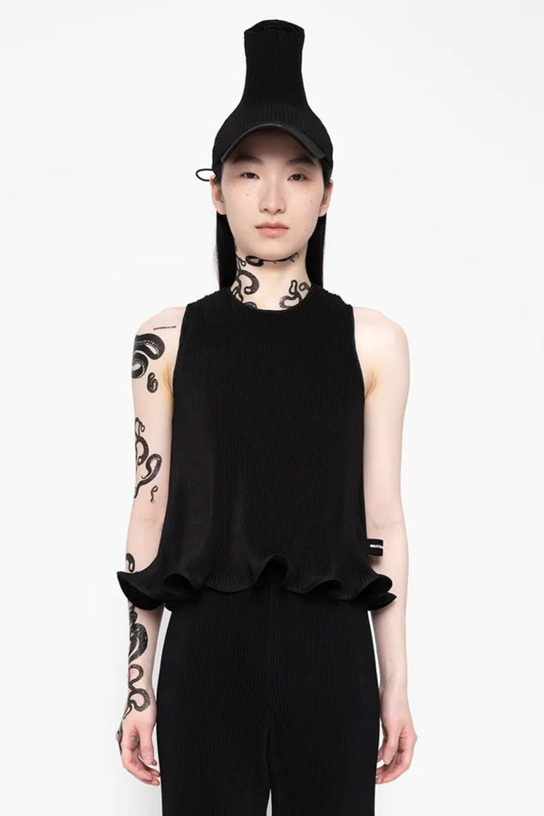 MELITTA-BAUMEISTER-Ripple-Ruffle-Tank-Black-LONG-BLACK-HAIR-FEMALE-MODEL-WITH-NECK-AND-LEFT-ARM-SNAKE-TATTOOS-ALSO-WEARING-BLACK-HAT-AND-HIGH-PLATFORM-BOW-LEATHER-SHOES