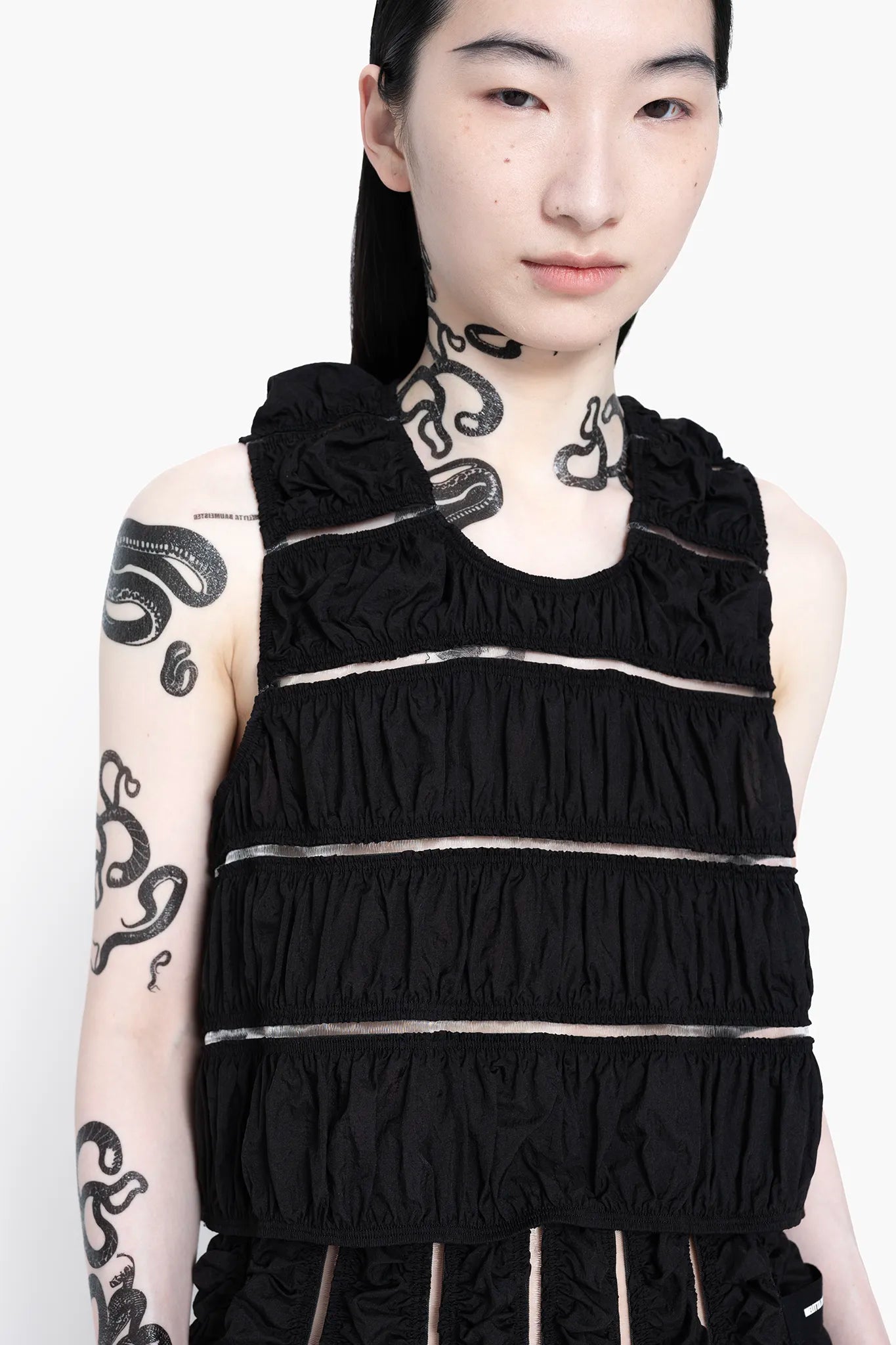 MELITTA-BAUMEISTER-Ruched-Tank-Black-LONG-BLACK-HAIR-FEMALE-MODEL-WITH-SNAKE-TATTOOS-ON-NECK-AND-RIGHT-ARM