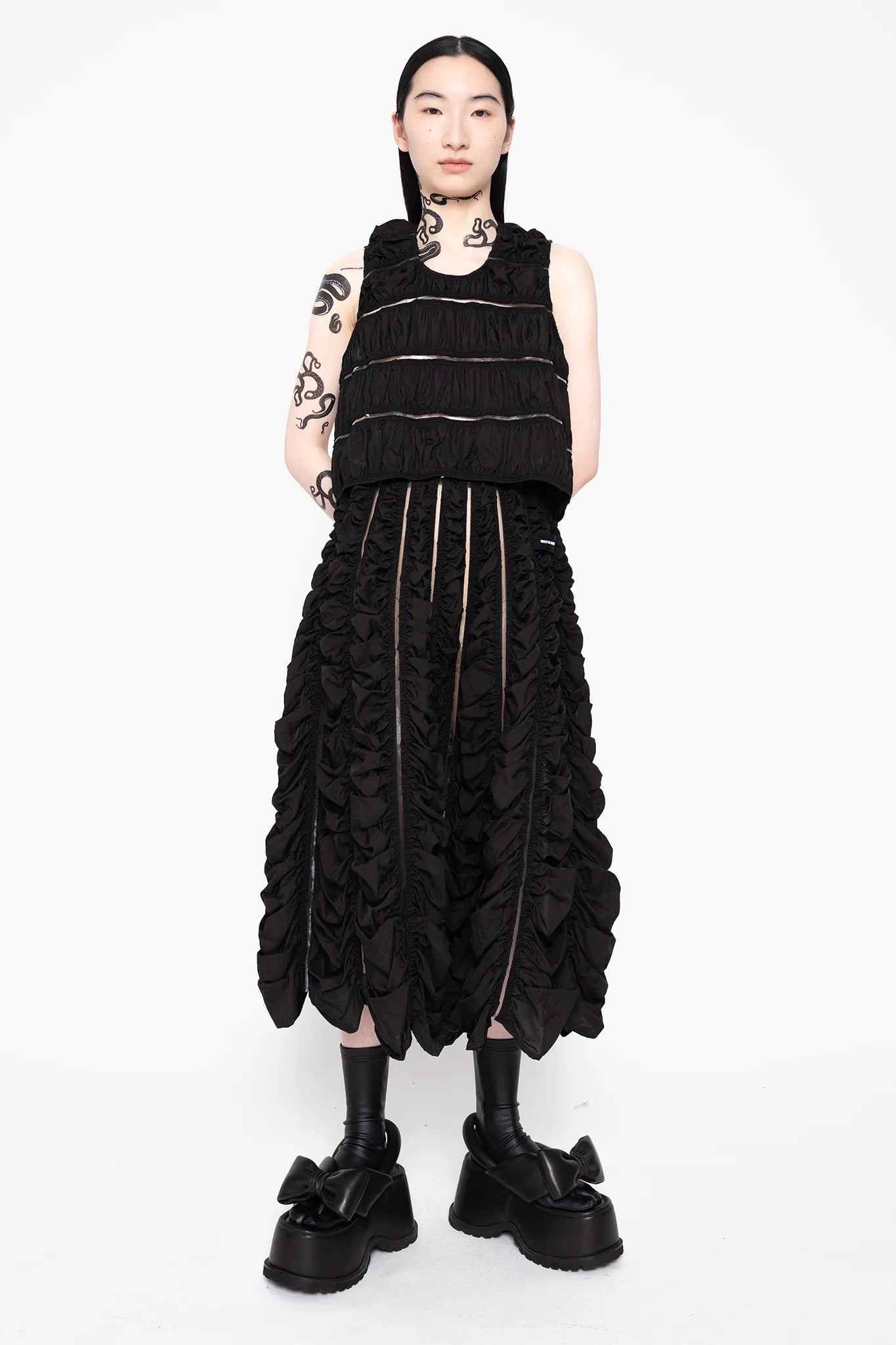 MELITTA-BAUMEISTER-Ruched-Tank-Black-FRONT-VIEW-FULL-BODY-WITH-SAME-MATERIAL-LONG-SKIRT-AND-BLACK-LEATHER-BOW-SHOES