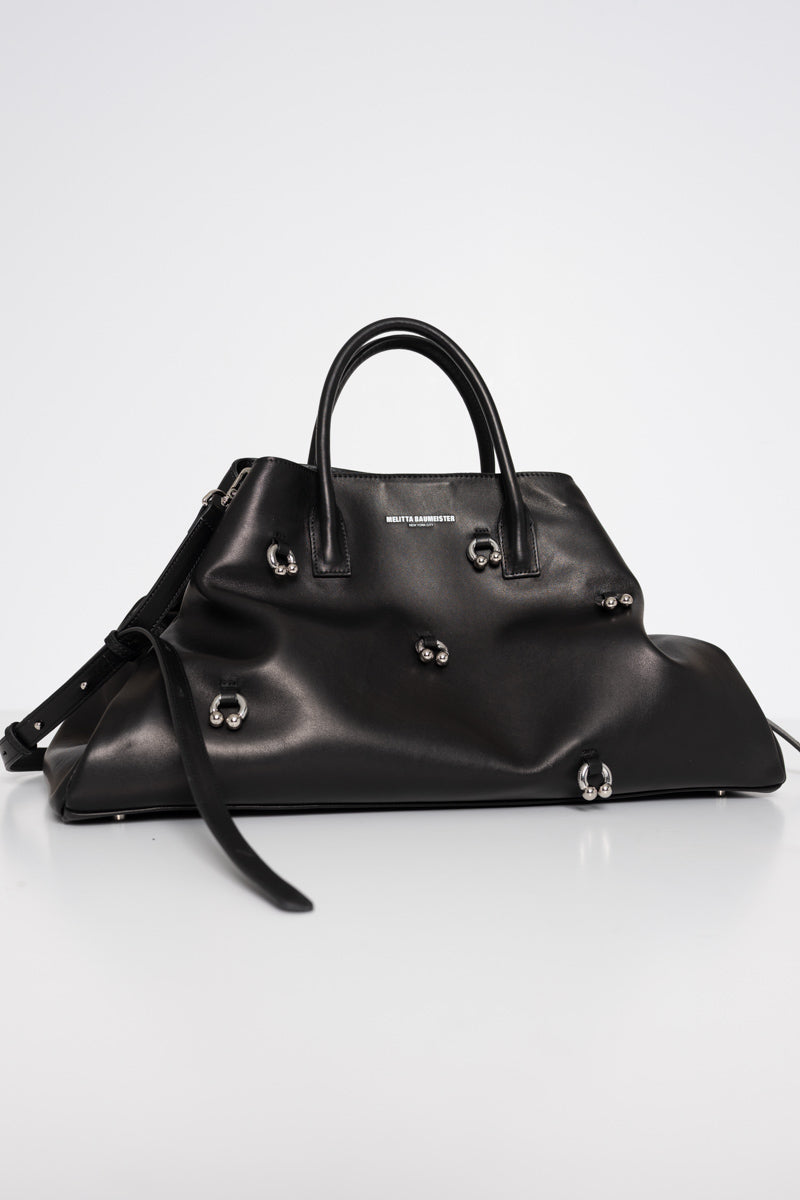 BLACK-COWHIDE-A-LINE-BAG-WITH-SHAOULDER-STRAPS-AND-CROSS-BODY-STRAPS-WITH-PIERCED-DETAIL-FRONT-VIEW