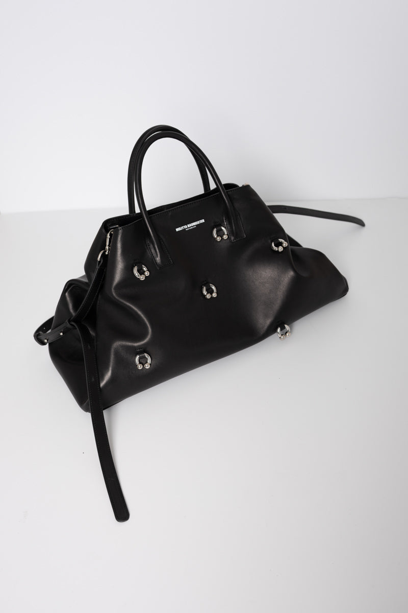 BLACK-COWHIDE-A-LINE-BAG-WITH-SHAOULDER-STRAPS-AND-CROSS-BODY-STRAPS-WITH-PIERCED-DETAIL-THREE-QUARTER-VIEW