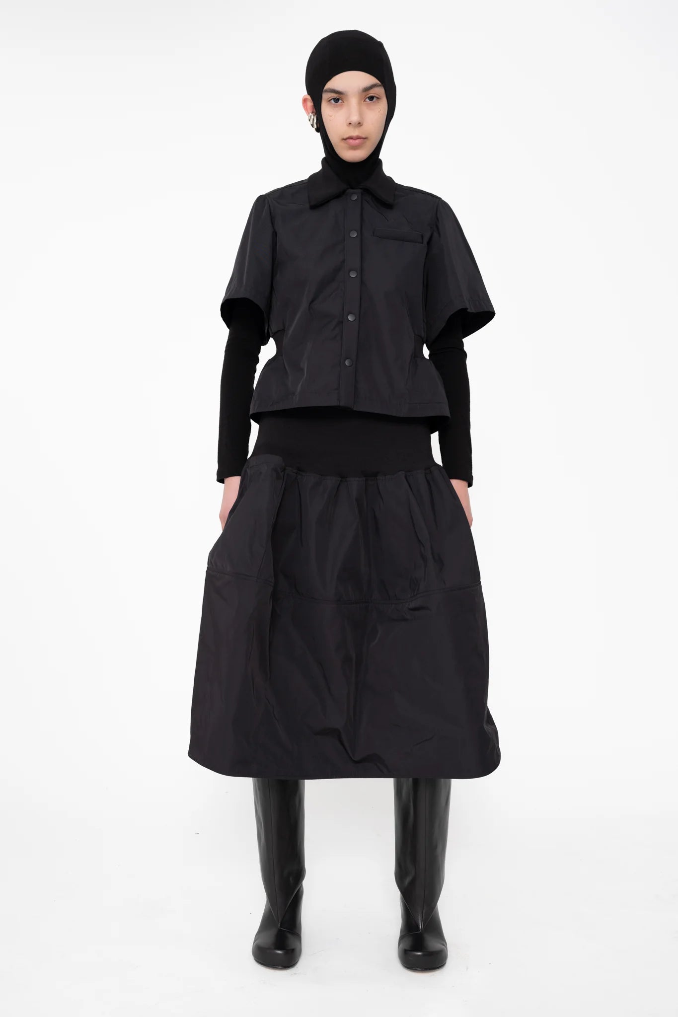 female-wearing-black-bomber-shirt-with-black-midi-skirt-on-white-background-full-body