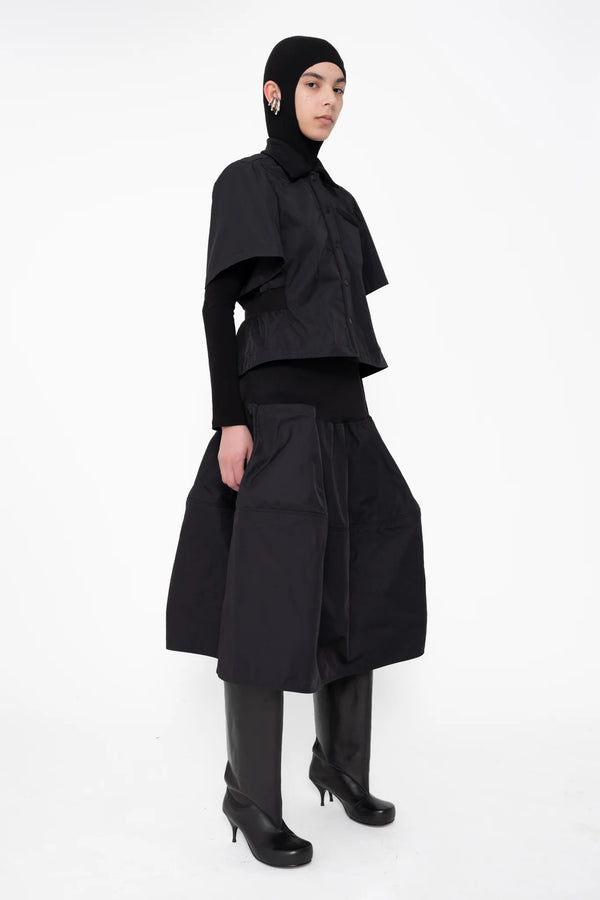 female-wearing-black-bomber-shirt-with-black-midi-skirt-on-white-background-full-body